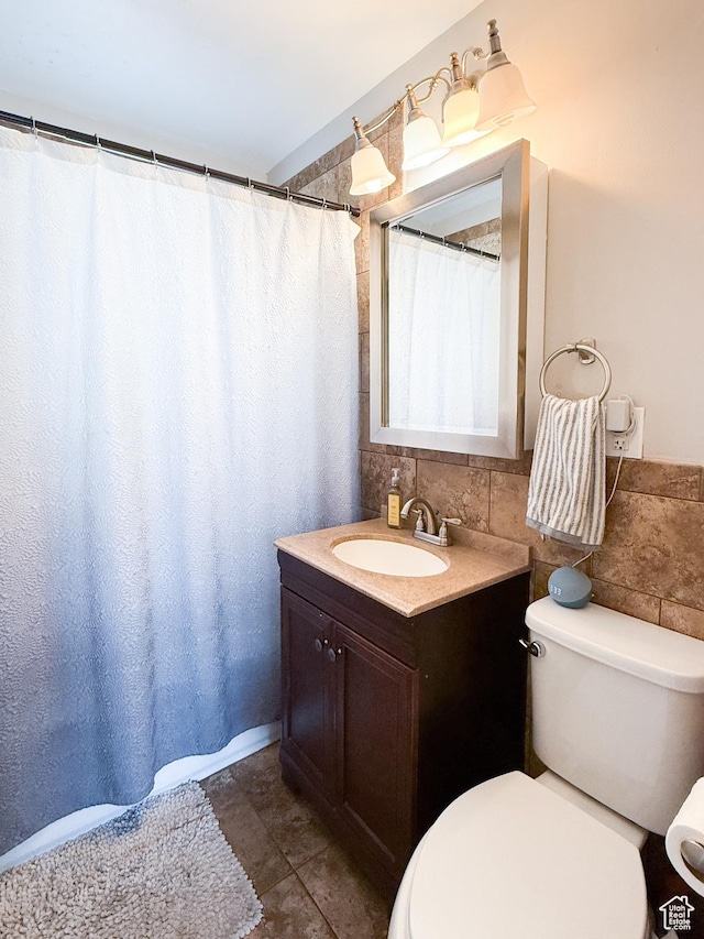 1054 34th St, Ogden, UT 84403 - bathroom with toilet, tile walls, vanity, and tile patterned flooring