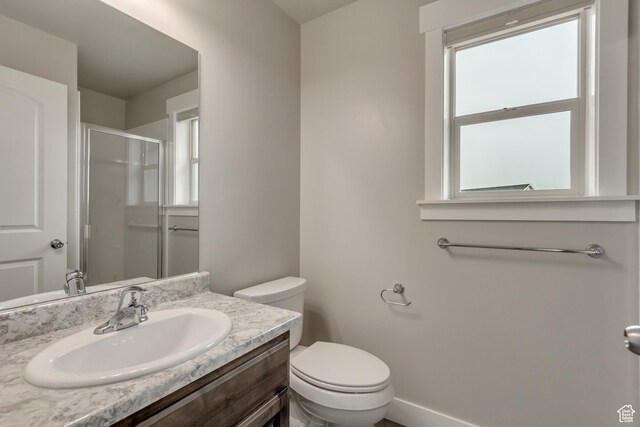 1879 E Tickville Cir, Eagle Mountain, UT 84005 - bathroom featuring toilet, baseboards, vanity, and a stall shower