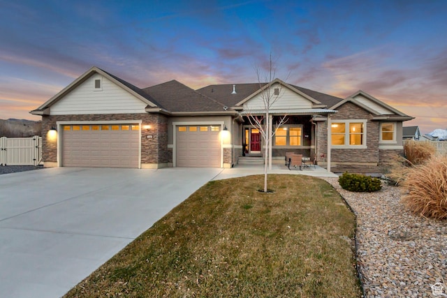 1879 E Tickville Cir, Eagle Mountain, UT 84005 - view of front of property with a garage, driveway, stone siding, and a lawn