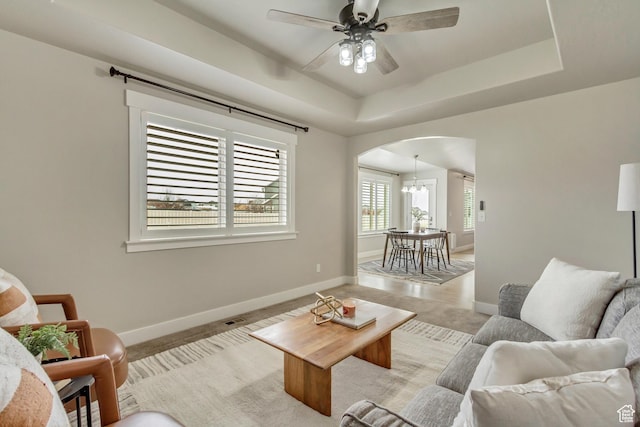 1879 E Tickville Cir, Eagle Mountain, UT 84005 - living room with arched walkways, baseboards, and light carpet