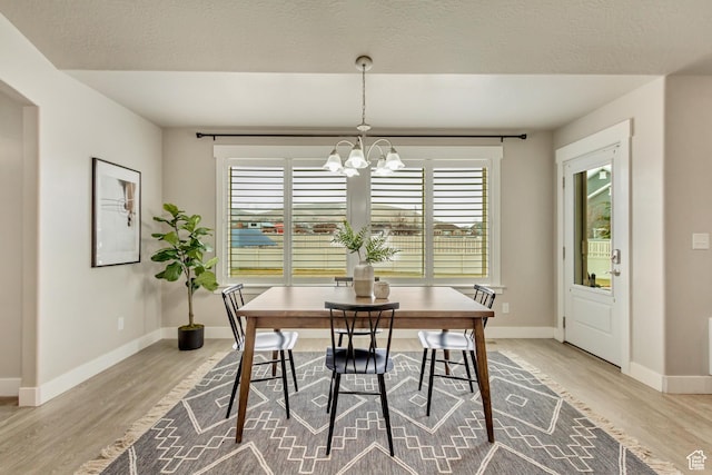 1879 E Tickville Cir, Eagle Mountain, UT 84005 - dining area with baseboards, an inviting chandelier, and light wood-type flooring