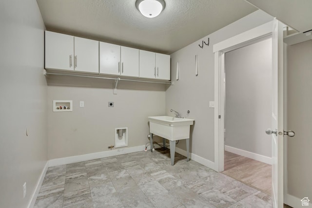 1879 E Tickville Cir, Eagle Mountain, UT 84005 - laundry area with hookup for an electric dryer, hookup for a washing machine, baseboards, cabinet space, and a textured ceiling