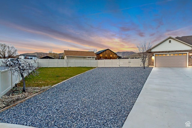 1879 E Tickville Cir, Eagle Mountain, UT 84005 - view of yard featuring fence private yard, driveway, and an attached garage