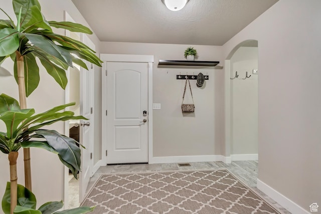 1879 E Tickville Cir, Eagle Mountain, UT 84005 - foyer entrance with baseboards and arched walkways