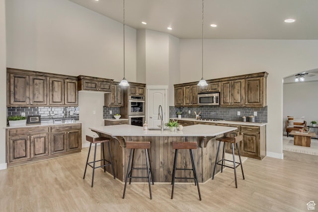 1879 E Tickville Cir, Eagle Mountain, UT 84005 - kitchen with light countertops, a sink, appliances with stainless steel finishes, and high vaulted ceiling
