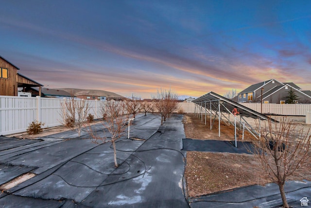 1879 E Tickville Cir, Eagle Mountain, UT 84005 - pool at dusk with a fenced backyard