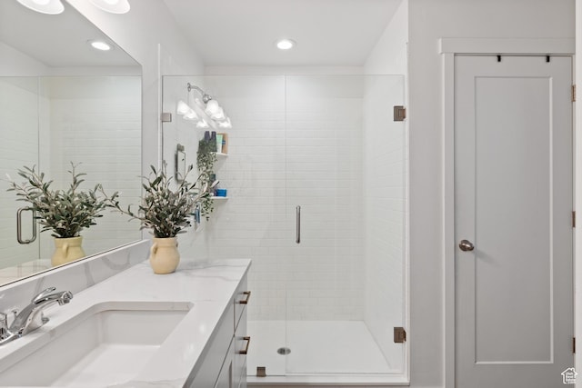 bathroom with a stall shower, recessed lighting, and vanity