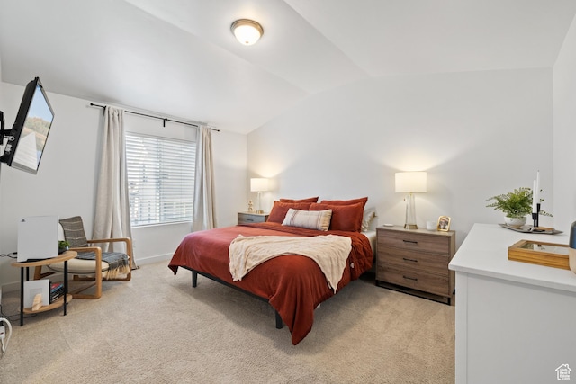 bedroom featuring baseboards, vaulted ceiling, and light colored carpet