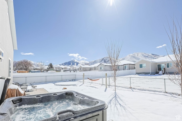 671 W 660 S, Tooele, UT 84074 - yard layered in snow featuring a fenced backyard, a mountain view, and a hot tub