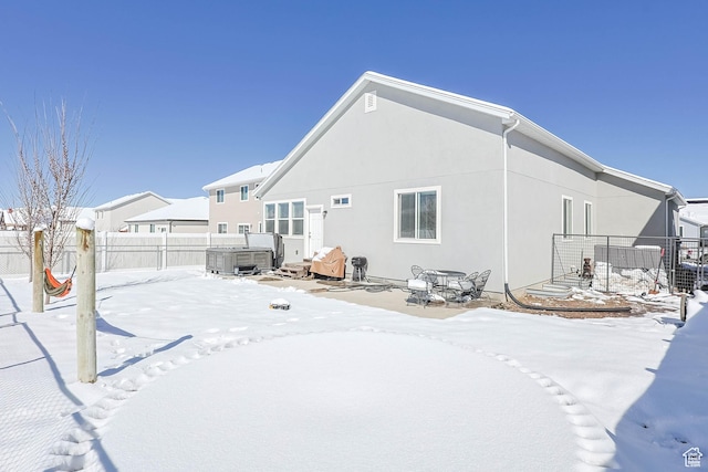 671 W 660 S, Tooele, UT 84074 - snow covered house featuring fence, stucco siding, and a hot tub