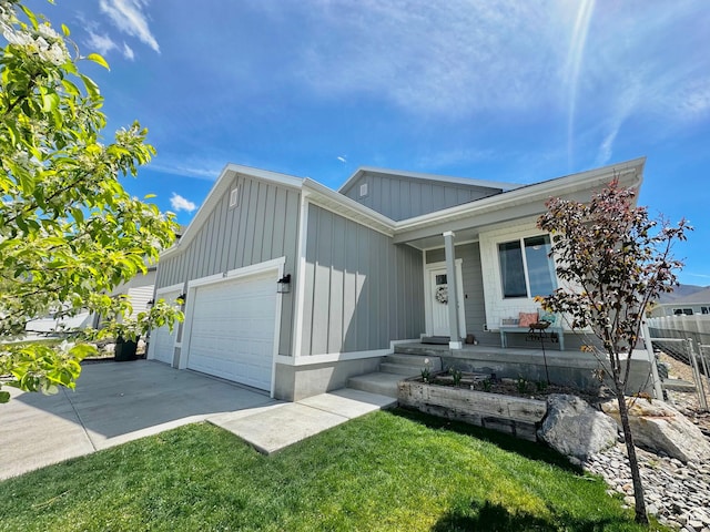 single story home featuring board and batten siding, a porch, a garage, a front yard, and concrete driveway