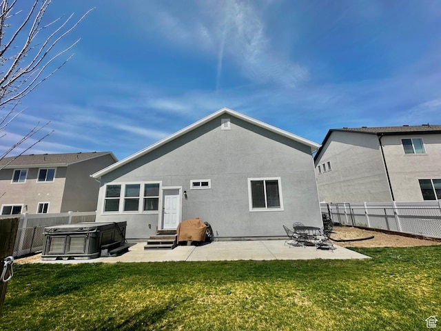 671 W 660 S, Tooele, UT 84074 - back of house featuring a lawn, a fenced backyard, and a hot tub