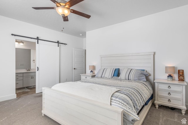 671 W 660 S, Tooele, UT 84074 - carpeted bedroom with a barn door, ensuite bathroom, a sink, baseboards, and a ceiling fan