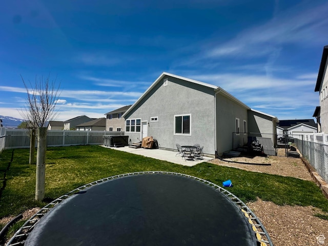 671 W 660 S, Tooele, UT 84074 - rear view of house featuring stucco siding, a patio area, a lawn, and a fenced backyard