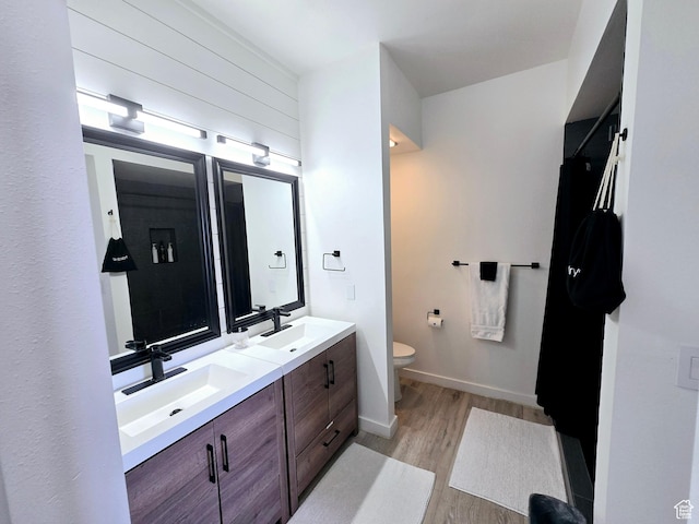900 Bitner Rd Unit G-32, Park City, UT 84098 - bathroom with baseboards, toilet, double vanity, wood finished floors, and a sink