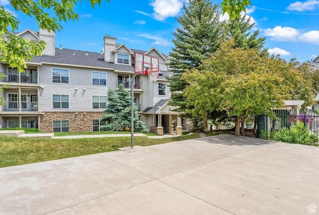 900 Bitner Rd Unit G-32, Park City, UT 84098 - exterior space with a front yard, fence, stone siding, and a chimney