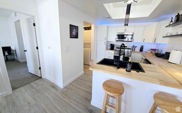 900 Bitner Rd Unit G-32, Park City, UT 84098 - kitchen with open shelves, a kitchen breakfast bar, appliances with stainless steel finishes, and a peninsula