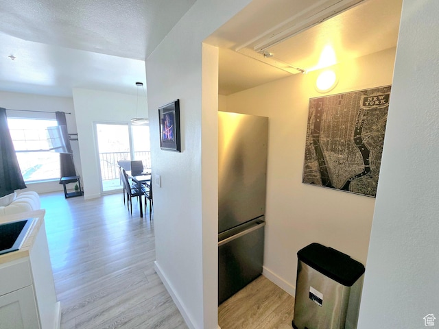 900 Bitner Rd Unit G-32, Park City, UT 84098 - kitchen with white cabinetry, baseboards, light wood-type flooring, and freestanding refrigerator