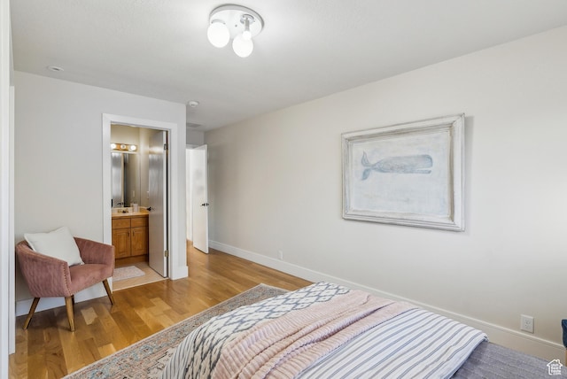 1919 E Baywood Dr, Holladay, UT 84117 - bedroom featuring light wood-style flooring, baseboards, a sink, and connected bathroom
