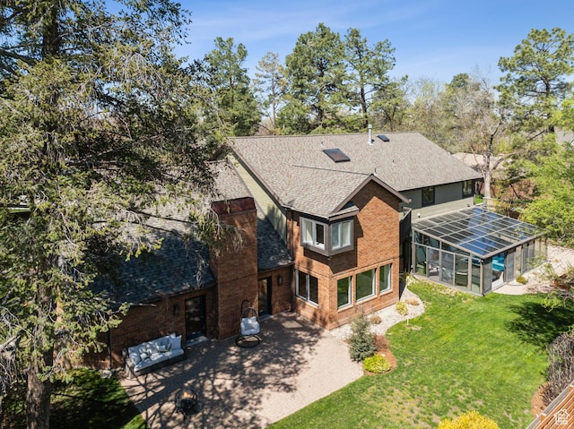 1919 E Baywood Dr, Holladay, UT 84117 - rear view of property featuring a shingled roof, a yard, a patio, brick siding, and a lanai