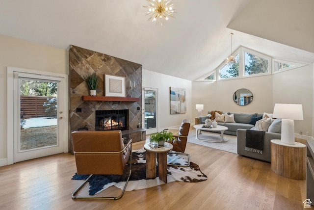 1919 E Baywood Dr, Holladay, UT 84117 - living area with a chandelier, a tiled fireplace, high vaulted ceiling, and wood finished floors