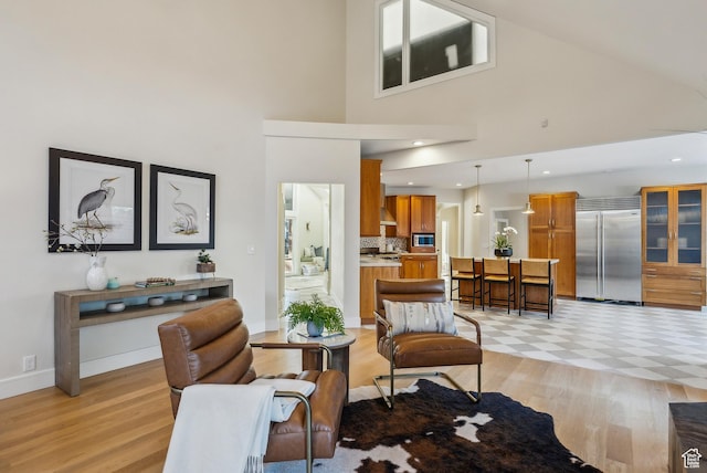 1919 E Baywood Dr, Holladay, UT 84117 - living area featuring light wood finished floors, a towering ceiling, and baseboards