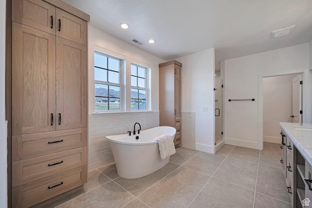 563 W Founders Blvd Unit 90, Saratoga Springs, UT 84045 - full bathroom with a stall shower, tile patterned flooring, a freestanding tub, vanity, and tile walls