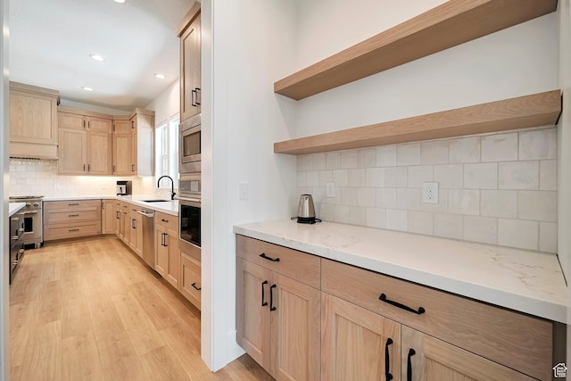563 W Founders Blvd Unit 90, Saratoga Springs, UT 84045 - kitchen with light brown cabinetry, a sink, tasteful backsplash, light wood finished floors, and appliances with stainless steel finishes