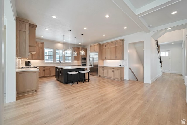 563 W Founders Blvd Unit 90, Saratoga Springs, UT 84045 - kitchen featuring built in appliances, light countertops, a kitchen island, recessed lighting, and a breakfast bar area