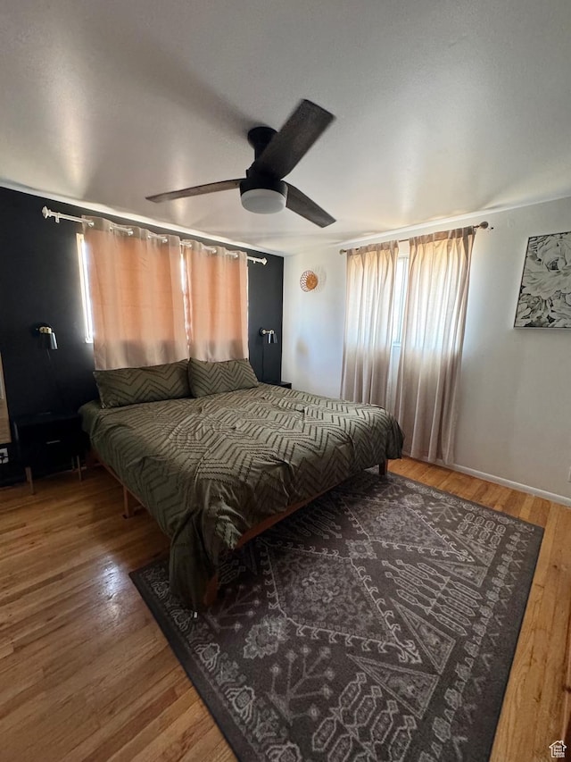 bedroom with wood finished floors and a ceiling fan