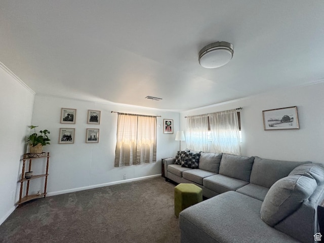 carpeted living room with visible vents, baseboards, and crown molding