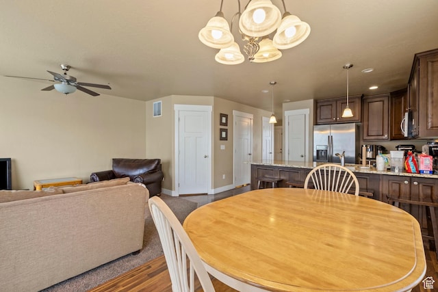 2043 W 1080 N, Provo, UT 84604 - dining area featuring wood finished floors, ceiling fan with notable chandelier, visible vents, and baseboards