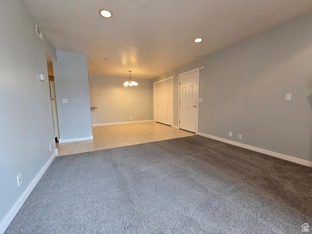 unfurnished room with light colored carpet, a chandelier, light tile patterned flooring, recessed lighting, and baseboards