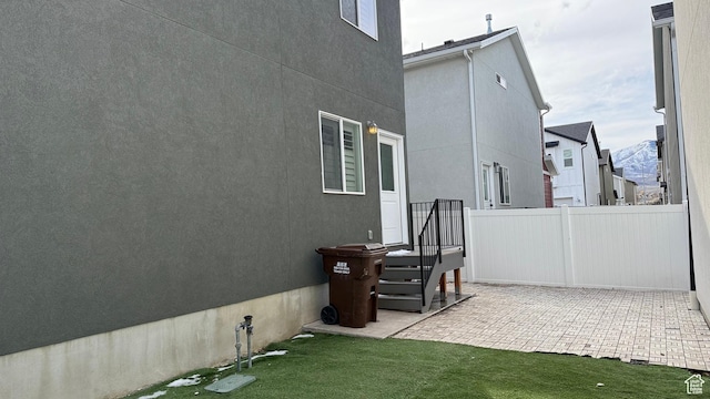 7886 S Fauna Ln W, West Jordan, UT 84081 - view of side of property featuring stucco siding, a patio, a yard, and fence