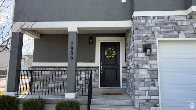 7886 S Fauna Ln W, West Jordan, UT 84081 - property entrance featuring a garage, stone siding, and stucco siding
