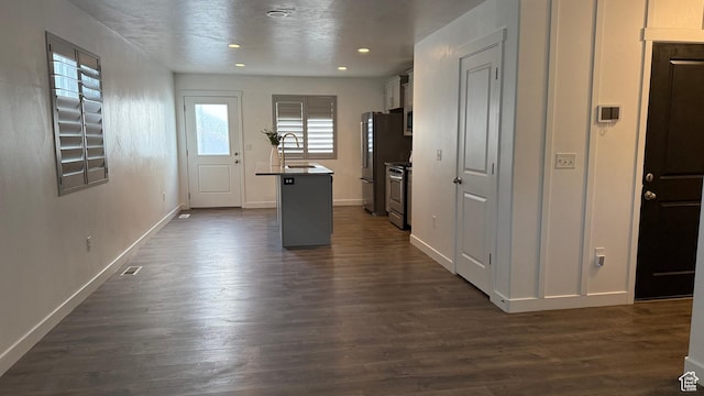 7886 S Fauna Ln W, West Jordan, UT 84081 - kitchen featuring dark wood finished floors, baseboards, appliances with stainless steel finishes, and a sink