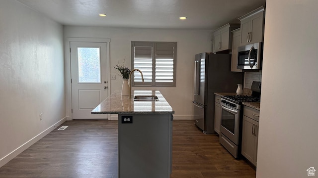 7886 S Fauna Ln W, West Jordan, UT 84081 - kitchen with baseboards, a sink, dark wood-type flooring, appliances with stainless steel finishes, and a center island