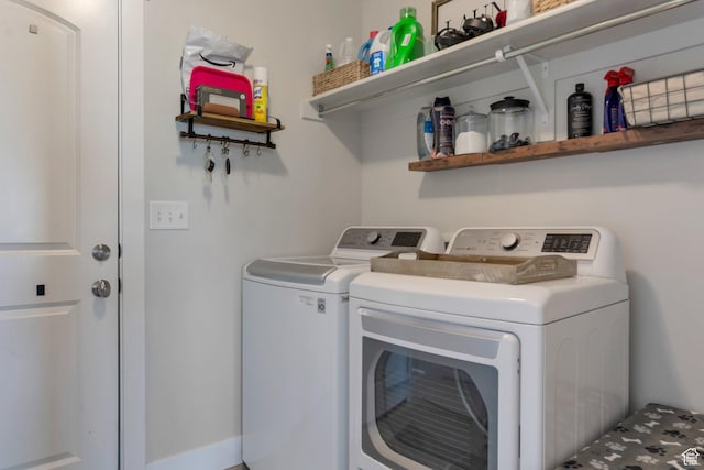 clothes washing area featuring laundry area and washing machine and clothes dryer