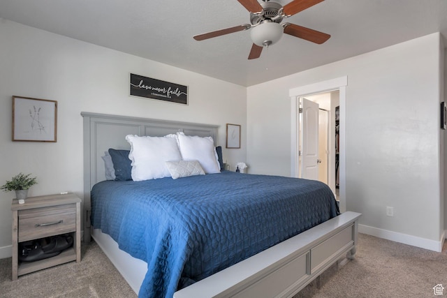 carpeted bedroom featuring a ceiling fan, baseboards, and connected bathroom