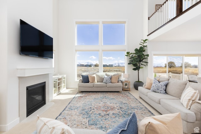 777 S Lake View Dr, Vineyard, UT 84059 - living room featuring a fireplace with flush hearth, carpet, and a towering ceiling