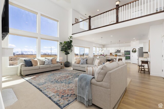 777 S Lake View Dr, Vineyard, UT 84059 - living area with light wood finished floors, recessed lighting, a high ceiling, and baseboards