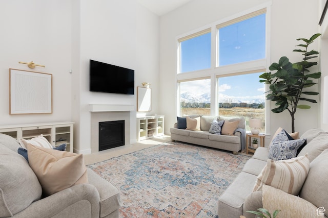 777 S Lake View Dr, Vineyard, UT 84059 - living area with a high ceiling, a fireplace with flush hearth, and carpet