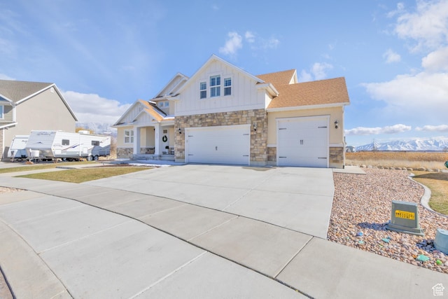 777 S Lake View Dr, Vineyard, UT 84059 - view of front of property featuring board and batten siding, an attached garage, concrete driveway, stone siding, and a mountain view