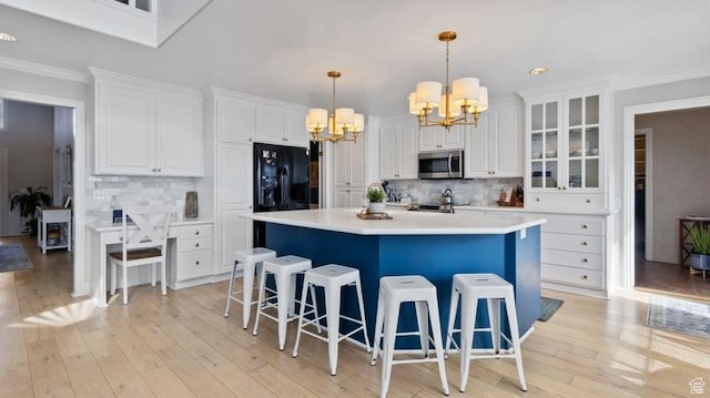 315 Stonehenge, Providence, UT 84332 - kitchen featuring ornamental molding, white cabinets, stainless steel microwave, a chandelier, and black refrigerator with ice dispenser