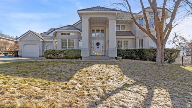 315 Stonehenge, Providence, UT 84332 - view of front of house featuring concrete driveway, a garage, and stucco siding