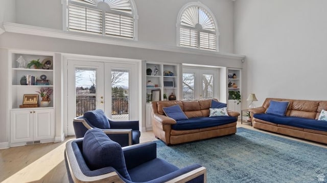315 Stonehenge, Providence, UT 84332 - living area with wood finished floors, french doors, a towering ceiling, and a healthy amount of sunlight
