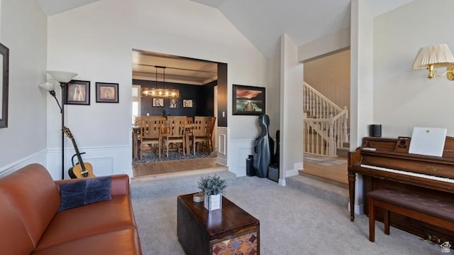 315 Stonehenge, Providence, UT 84332 - carpeted living room featuring a chandelier, a wainscoted wall, stairs, vaulted ceiling, and a decorative wall