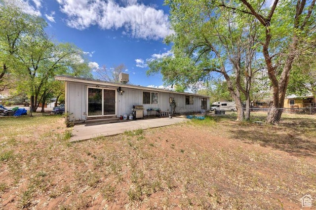 451 & Dr, Moab, UT 84532 - rear view of house with fence, a chimney, board and batten siding, and a patio area