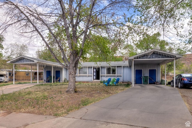 451 & Dr, Moab, UT 84532 - single story home with board and batten siding, a carport, and driveway