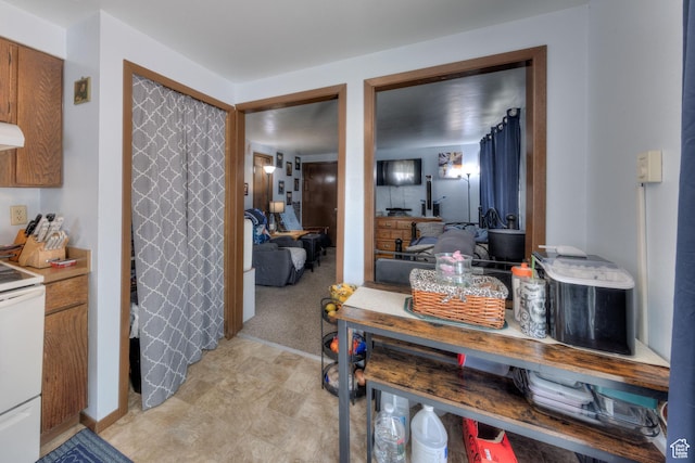 451 & Dr, Moab, UT 84532 - kitchen featuring white range with electric cooktop, brown cabinets, and light countertops